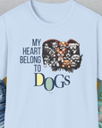 The My Heart Belongs to Dogs, Volume 1 light blue unisex T-shirt showcases cartoon dogs with the funny saying My Heart Belongs to Dogs. Designed by Dog Gang.