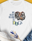 The Womens T-shirt, My Heart Belongs To Dogs, Volume 1, showcases a cute dog design with an adorable illustration and the phrase My Heart Belongs to Dogs. Designed by Dog Gang.