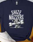 Discover the Shize Mazzers, Volume 1 t-shirt in navy blue, featuring a funny cartoon dog holding an oversized bone in its mouth, preventing it from speaking properly. The text reads "SHIZE MAZZERS". Perfect for any dog ​​lover. Designed by Dog Gang.